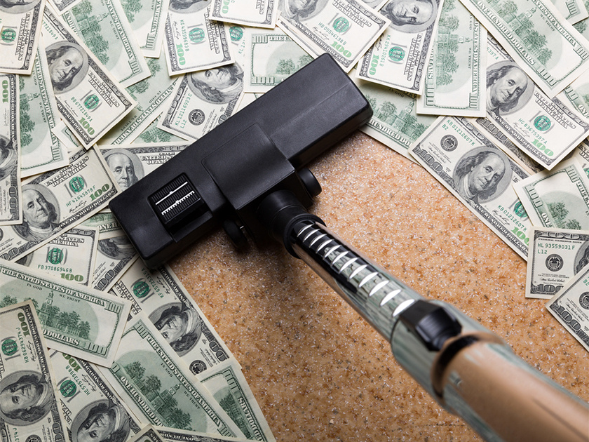 Money on the floor vacuuming with vacuum cleaner